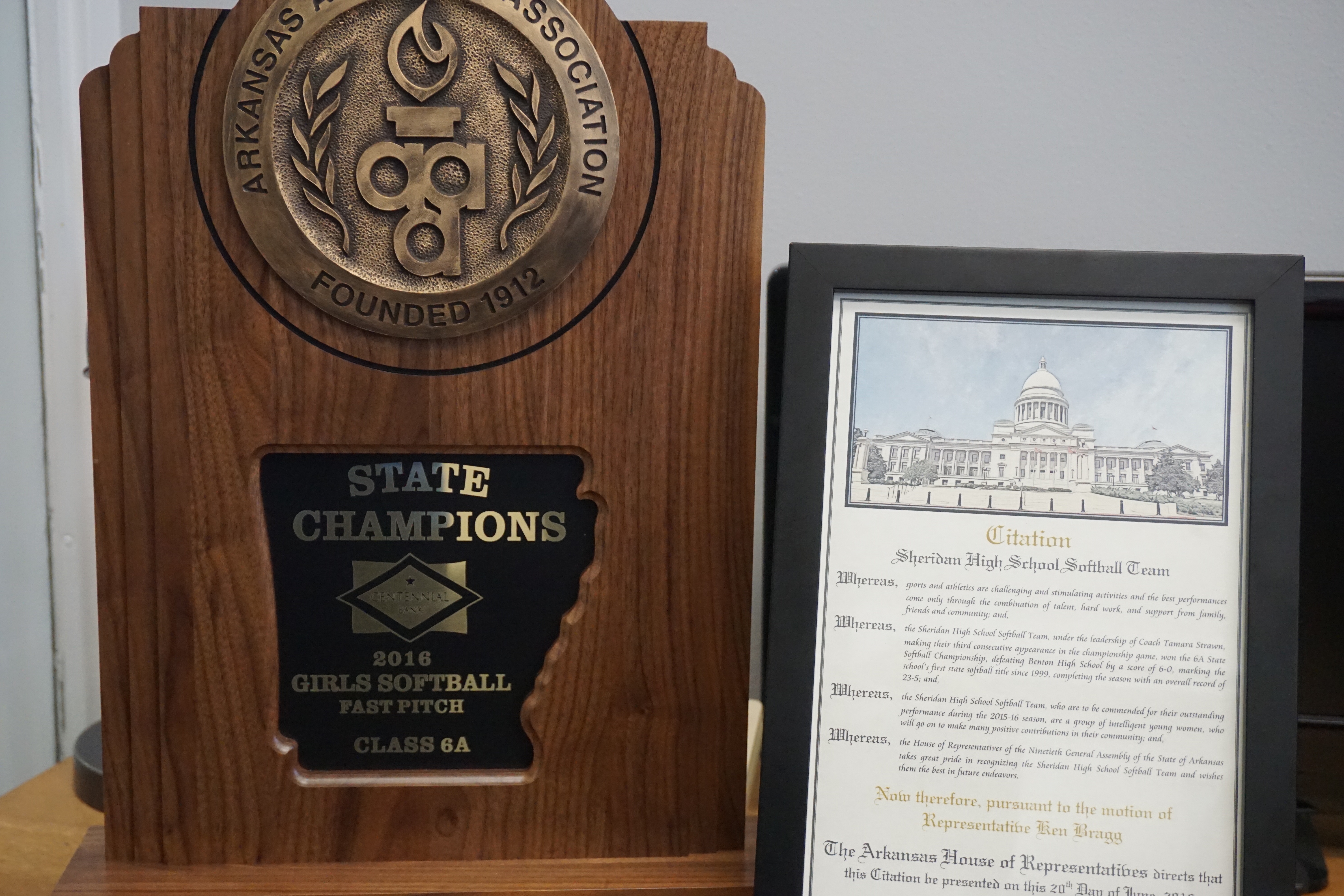 State Champions plaque next to print out of Rep. Ken Bragg's citation 